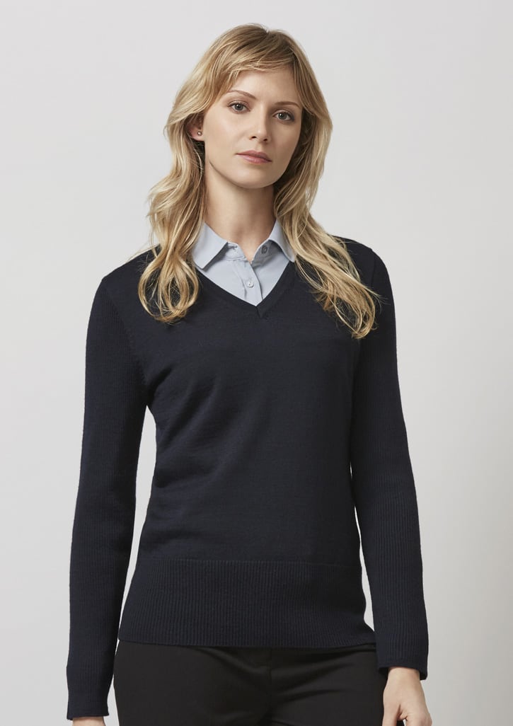 A dark navy pullover jumper with a V-neck design, worn over a light blue shirt. It features long sleeves and a fitted style.