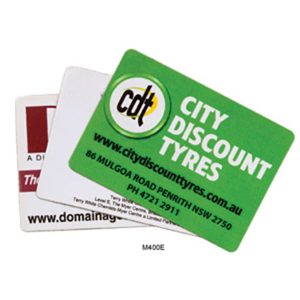 Three rounded corner fridge magnets in various colours, featuring different logos and designs, including one with a green background.