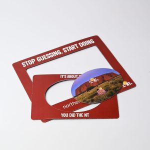 A magnetic photo frame set in a rich red colour, featuring a circular insert and a logo.