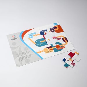 A magnetic jigsaw puzzle in various colours, featuring a unique design and several loose puzzle pieces.