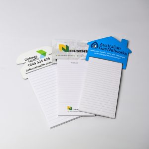 A set of magnetic to-do lists in white, including various branded designs and a house-shaped notepad, marked Australian made.