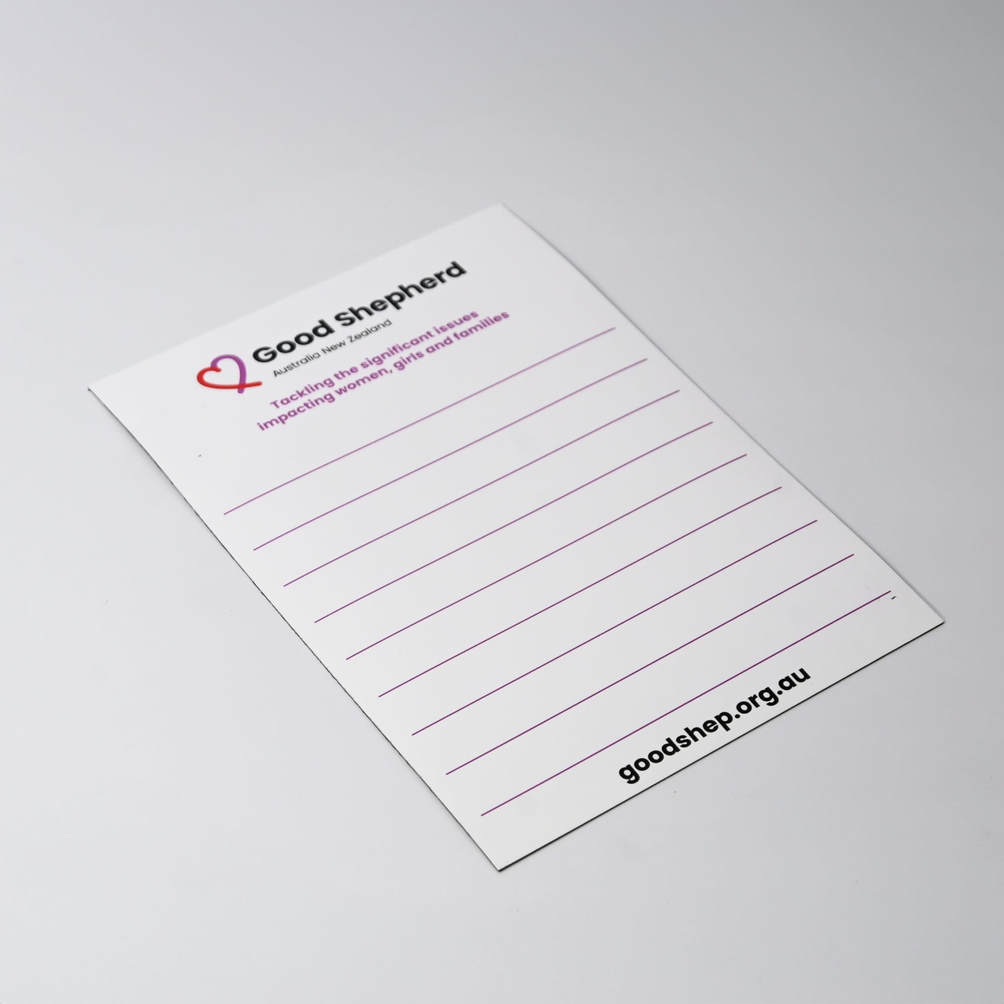 A white magnetic whiteboard featuring lined sections and a logo in the corner. It has a smooth, glossy finish.