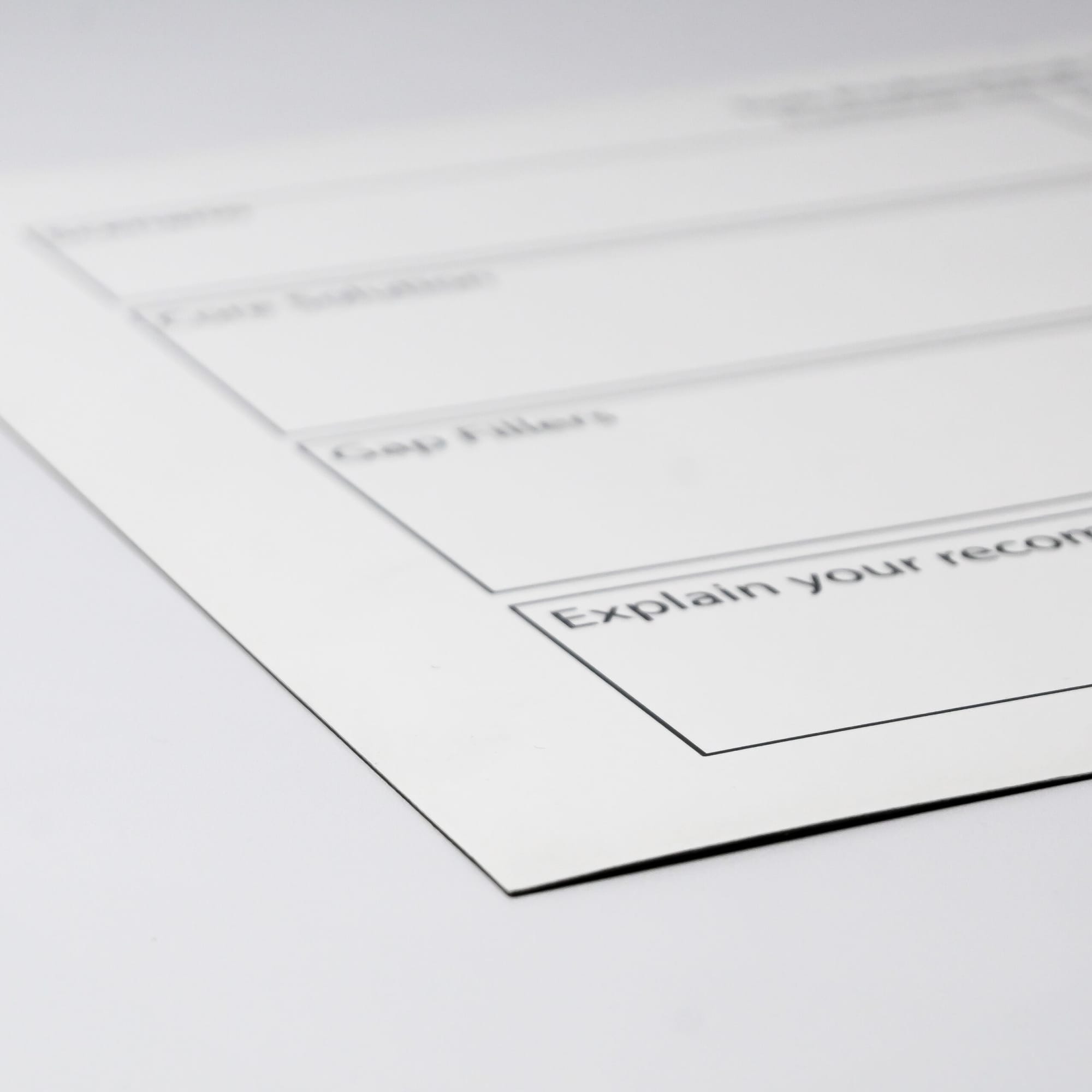 A white magnetic whiteboard with black outline sections for notes, featuring a logo in the corner.