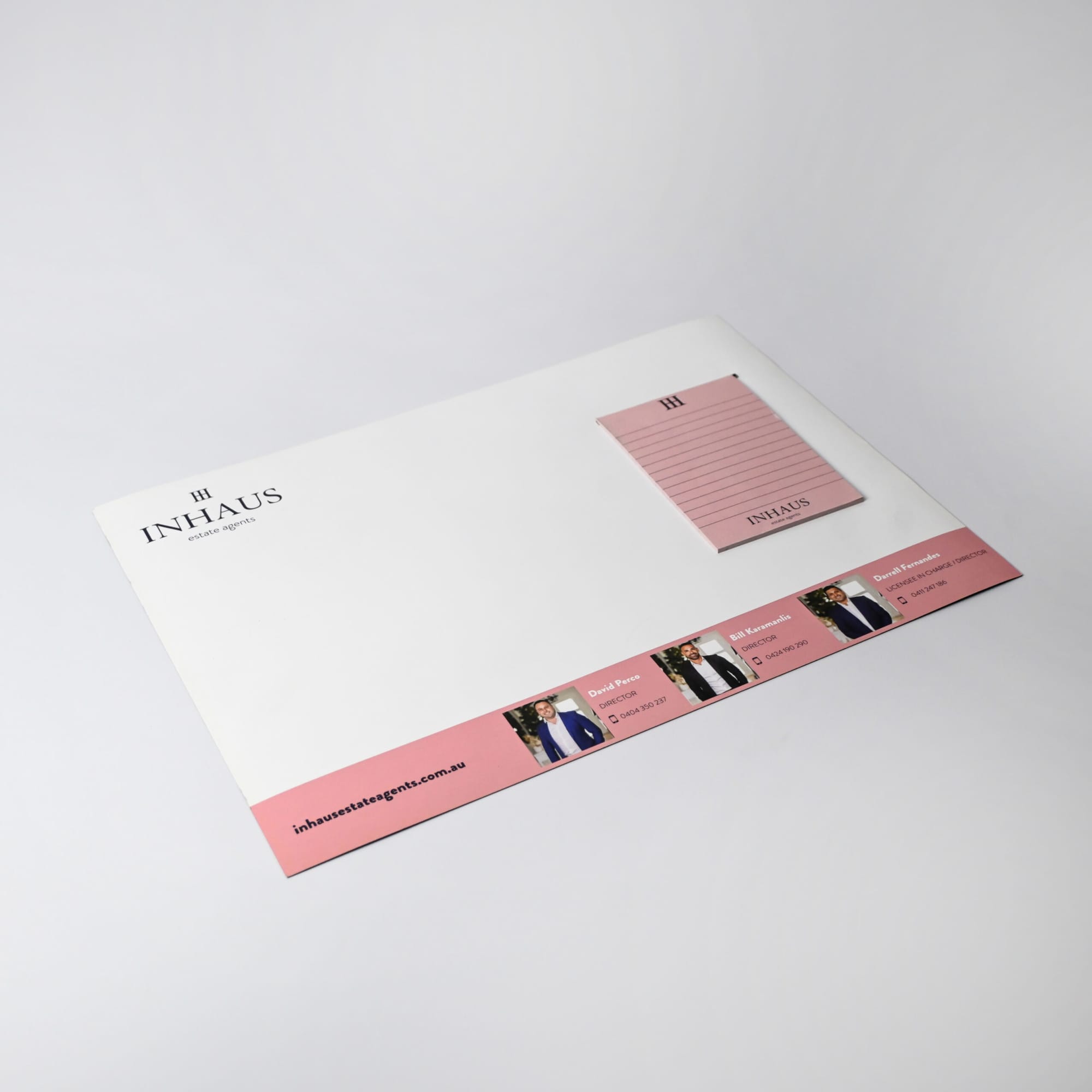 A3 magnetic whiteboard in white featuring a pink notepad, with a logo and branding on the bottom section.