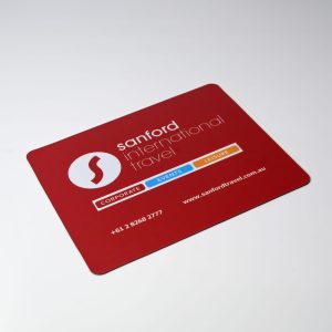 A red mouse mat featuring a logo, with contact details and categories for corporate, events, and leisure services.