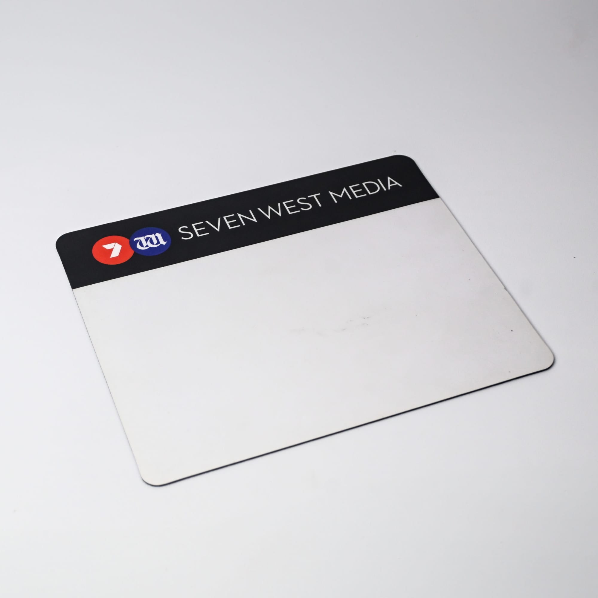 A rectangular mouse mat in black and white, featuring a logo and a blank surface for personalisation.