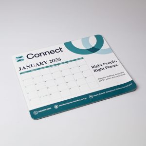 A mouse mat featuring a calendar for January 2025, in blue and green tones, with a logo and Australian-made badge.