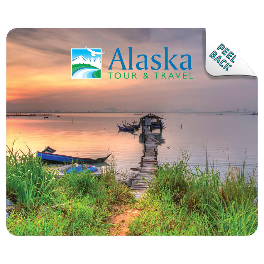 A mouse mat featuring a scenic image of a pier at sunset, with greenery and boats, showcasing blue and earthy tones.