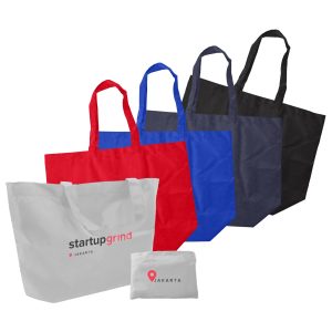 A collection of foldaway shopping bags in red, blue, black, and white, featuring a logo on each bag.