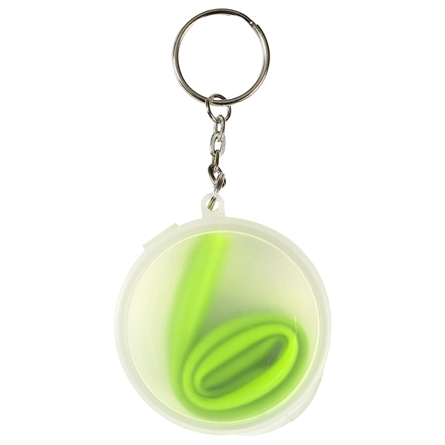 A green reusable silicone straw coiled inside a transparent case, attached to a keyring.