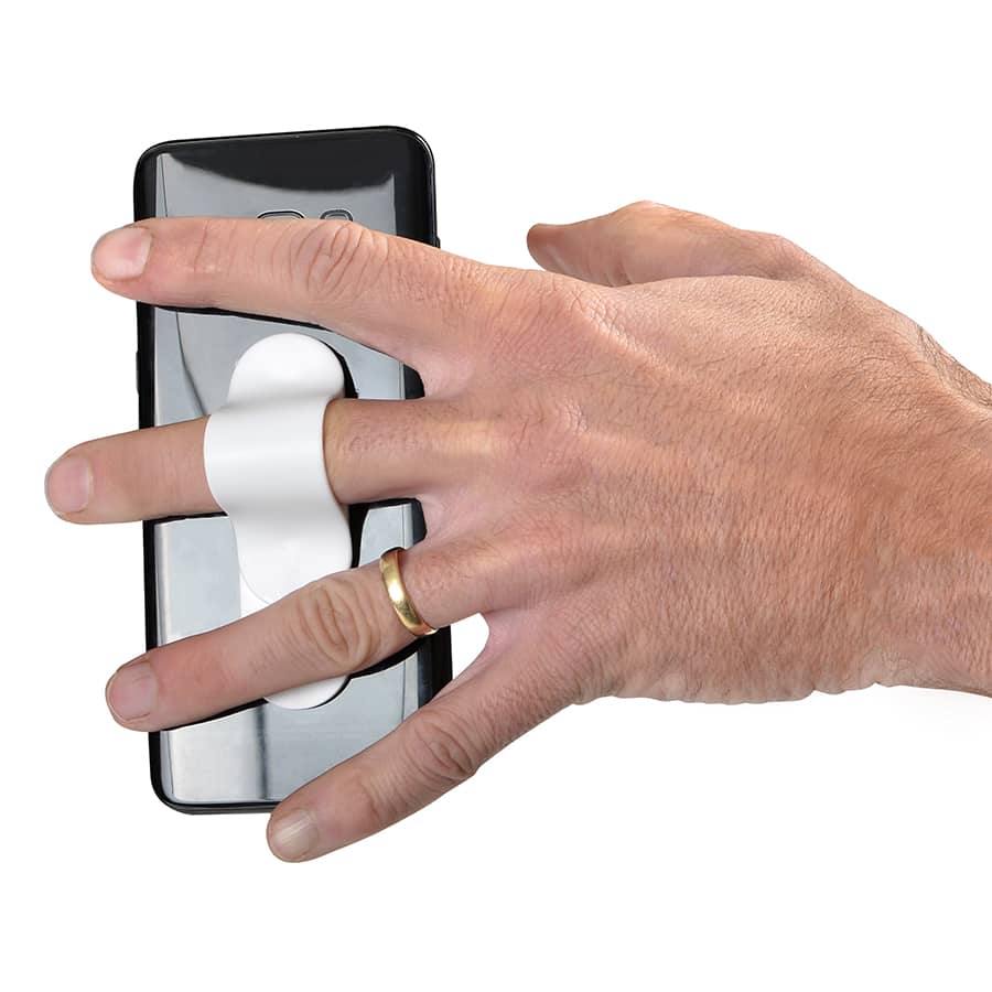 A black smartphone with a white strap attached, held by a hand wearing a gold ring.