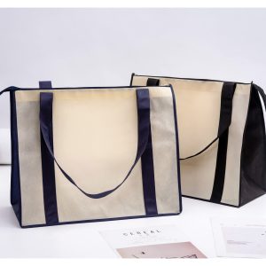 Two large zipped shopping bags in beige and black, featuring handles and a branding logo.