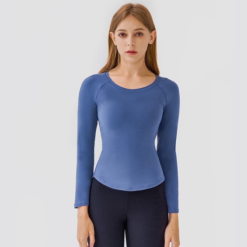 A long sleeve yoga top in a soft blue colour, featuring a round neckline and fitted design.