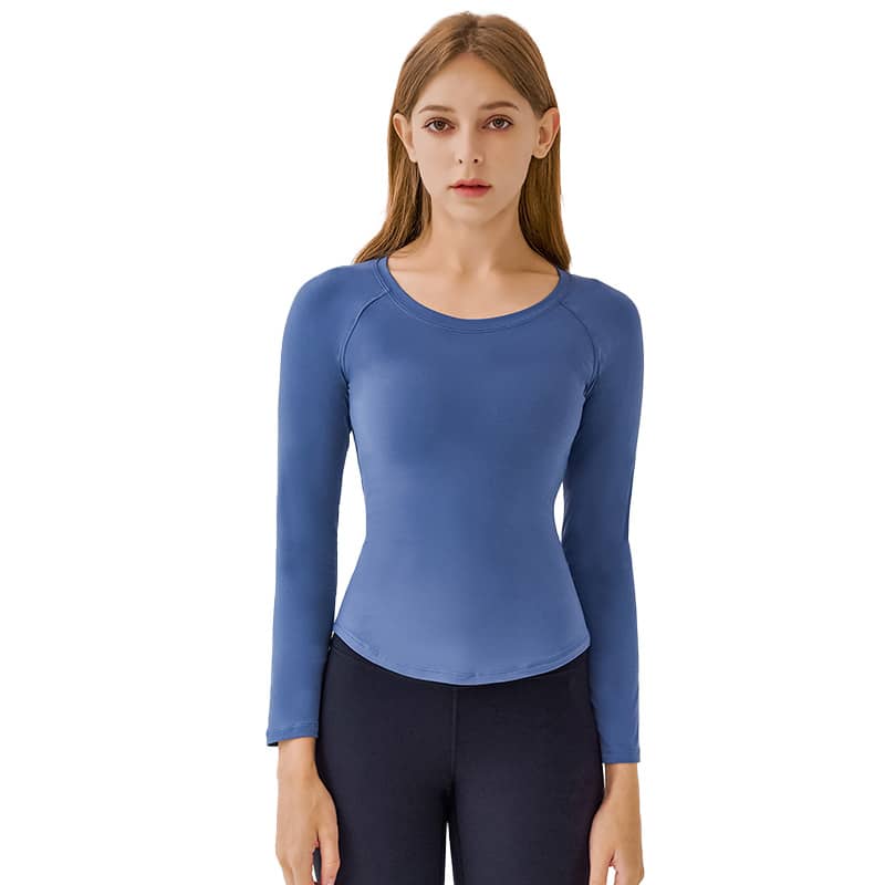 A long sleeve top in a light blue shade, featuring a round neckline and a fitted design. It has a logo on the sleeve.