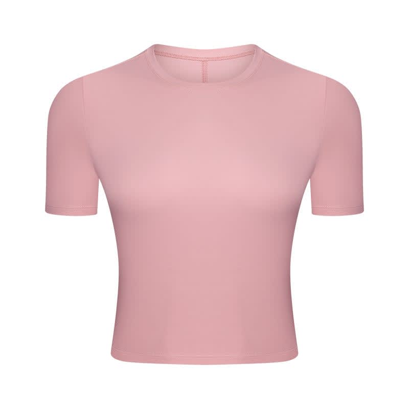 A pink short sleeve yoga top with a fitted design and a logo on the front.