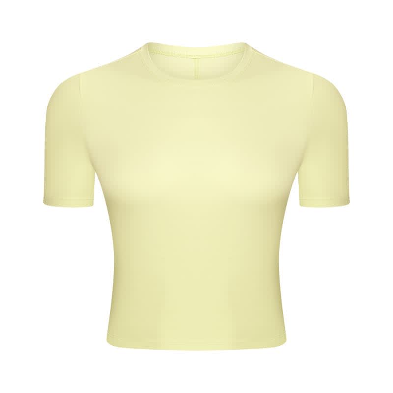 A short sleeve yoga top in a pale yellow shade, featuring a simple design and a logo.