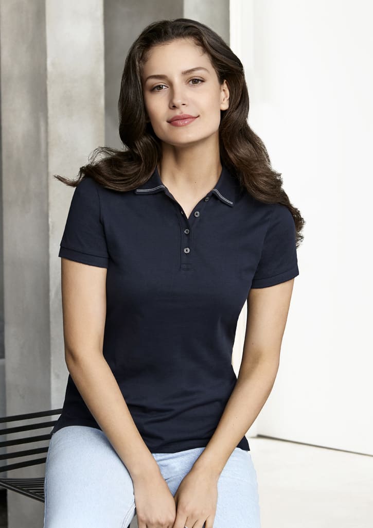 A navy women's polo shirt with short sleeves, featuring a collar and buttons, designed for casual wear.