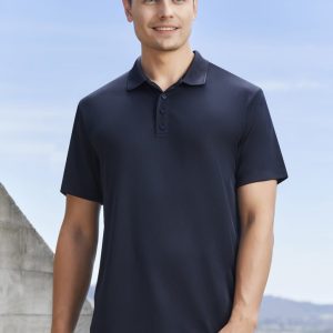 A navy blue men's short sleeve polo shirt, featuring a collar and buttons, worn by a smiling male model outdoors.