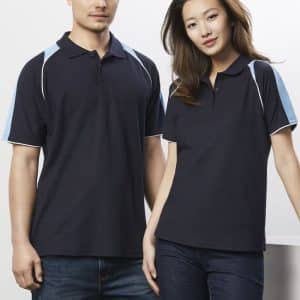 A navy blue women's polo shirt with light blue accents, featuring a collar and side detailing. It has a branding logo.