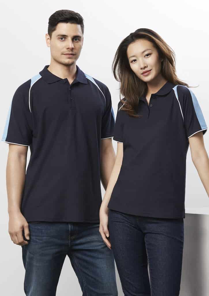 A navy blue women's polo shirt with light blue accents, featuring a collar and side detailing. It has a branding logo.