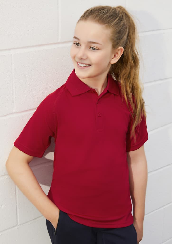 A red short sleeve polo shirt for kids, featuring a collar and a branding logo.