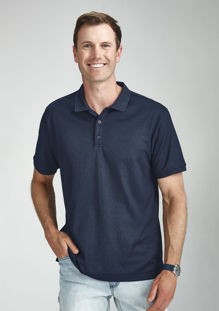 A navy blue short sleeve polo shirt with a collar and a logo, worn by a smiling man.