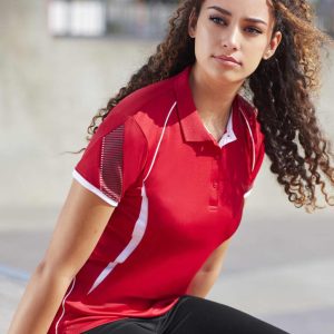 A red women's short sleeve polo shirt with white accents and a logo. The model is sitting outdoors.
