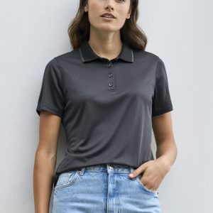 A women's short sleeve polo shirt in black, featuring a collar and a button placket, paired with light blue jeans.
