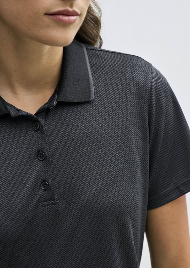 A women's short sleeve polo shirt in black with a textured pattern and a classic collar. Features a logo on the chest.