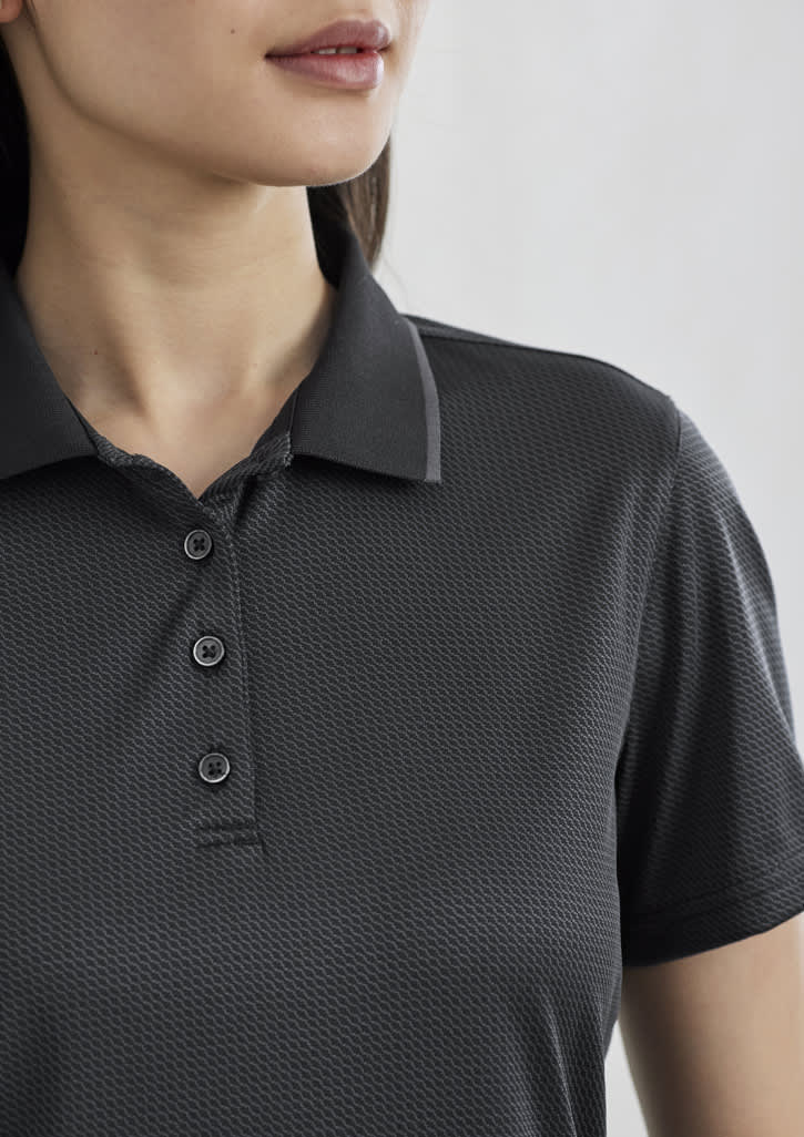 A women's short sleeve polo shirt in black with a textured pattern and a button-up collar. It features a logo.