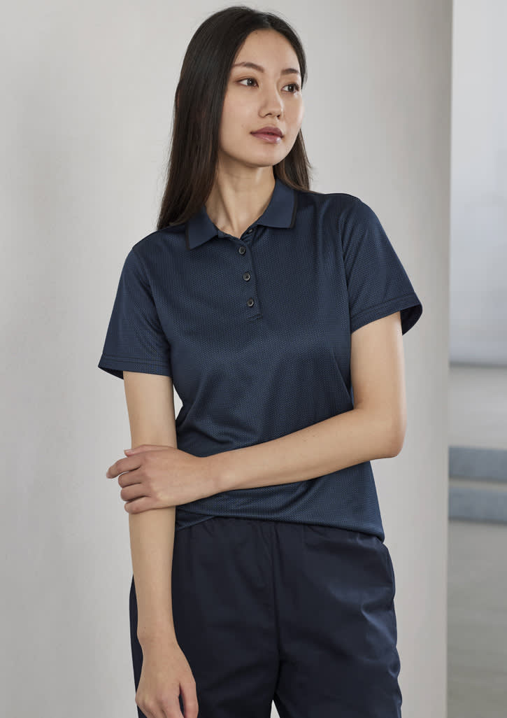 A women's short sleeve polo shirt in navy blue, featuring a logo and a classic collar design.