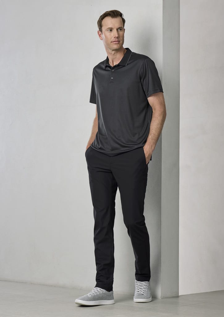 A dark grey men's short sleeve polo shirt displayed on a model, paired with black trousers and grey shoes.