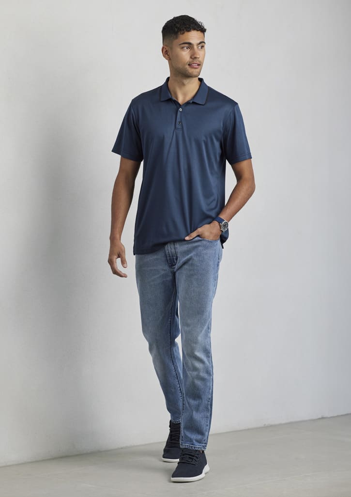 A navy blue short sleeve polo shirt with a collar, worn by a model paired with light blue jeans and casual shoes.