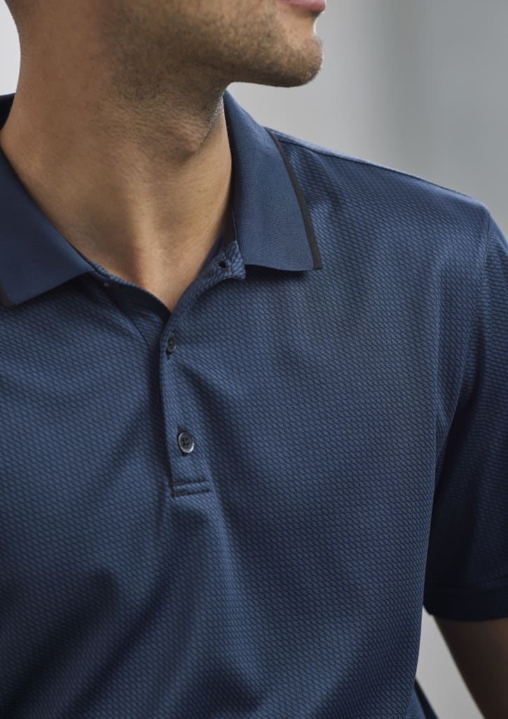 A navy blue men's short sleeve polo shirt featuring a textured pattern and a collar with a logo.