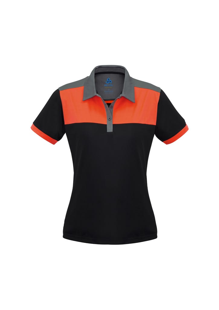 A women's polo shirt in black with orange and grey panels, featuring a collar and a logo.