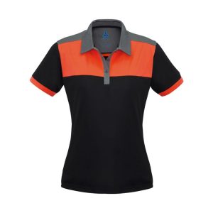 A women's polo shirt in black with orange and grey panels, featuring a collar and a logo.