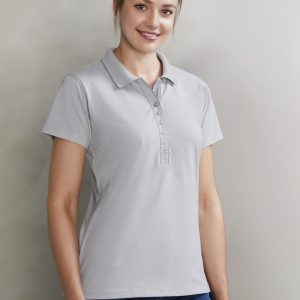 A light grey women's polo shirt with a button placket and a logo on the chest, styled with blue jeans.
