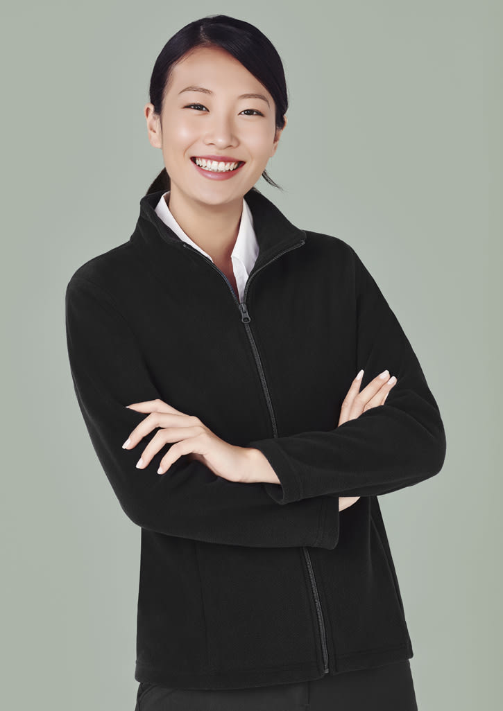 A black women's plain micro fleece jacket with a zipped front, featuring a logo, worn by a smiling woman.