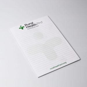 A5 notepad with 25 leaves, featuring a green logo, white background, and lined pages. Australian made.