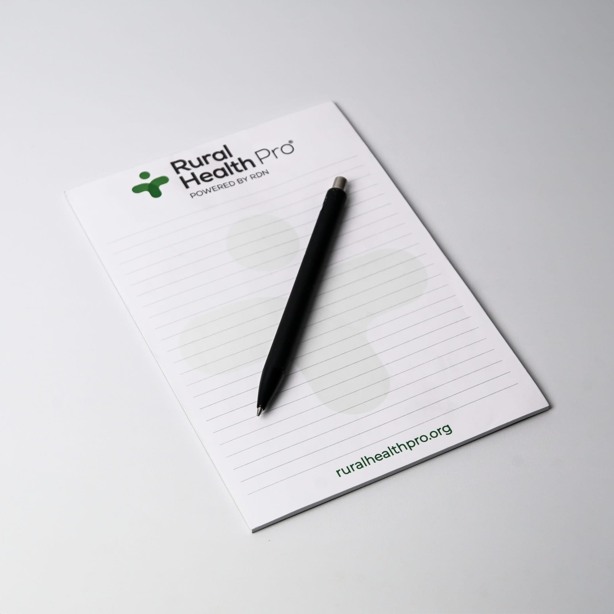 A5 notepad with 25 leaves, featuring a white background and a black pen, includes a logo at the top.