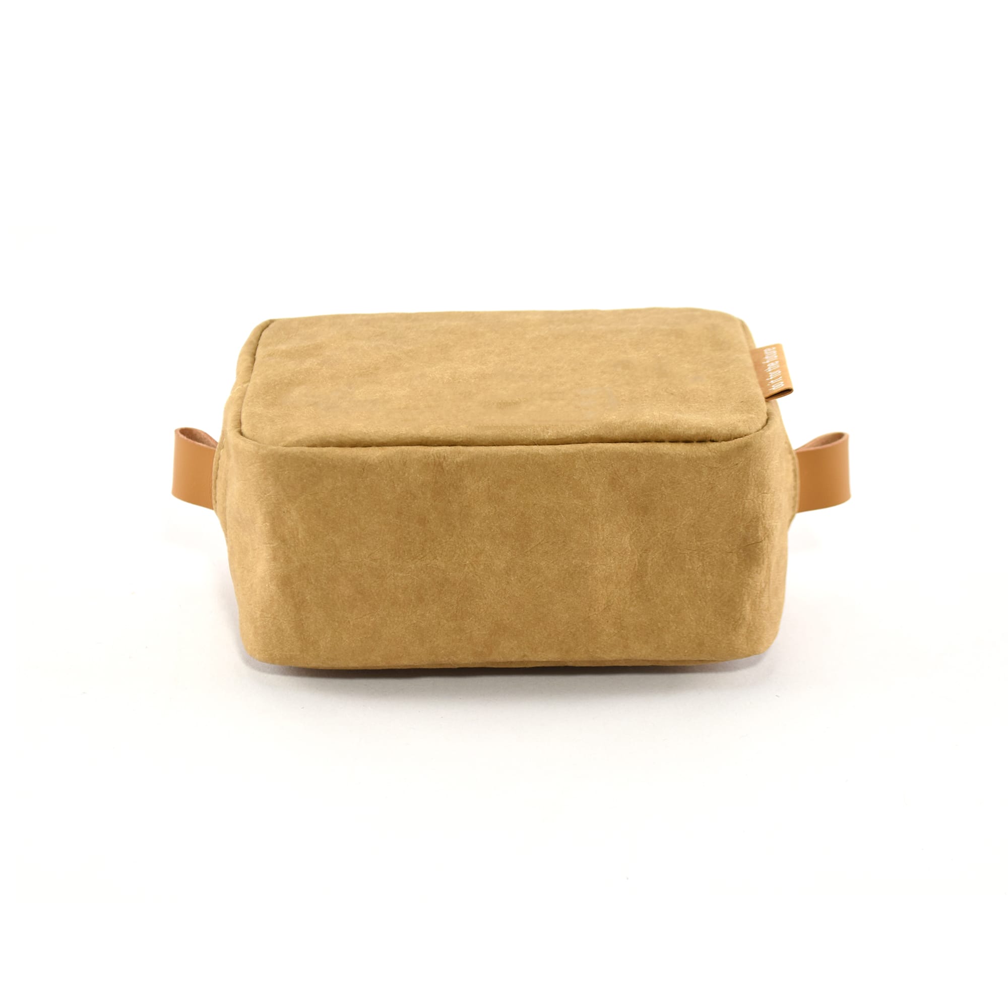 A tan kraft paper cosmetic bag with a rectangular shape and leather-like handles. It features a logo.
