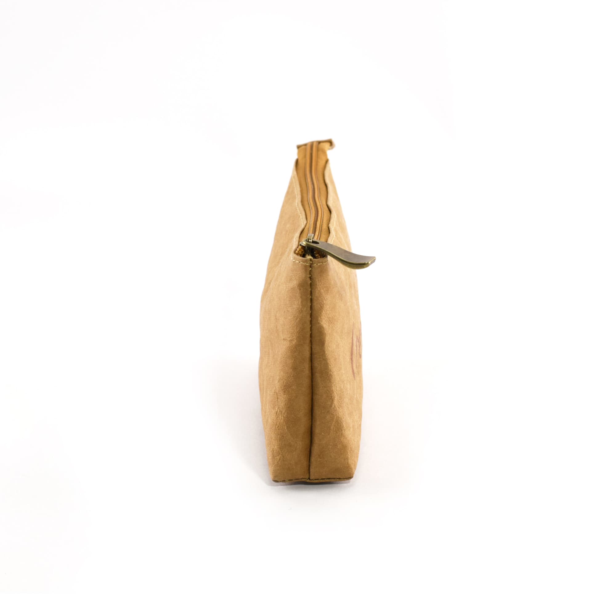 A side view of a tan Kraft paper cosmetic bag with a zipper closure and a metallic pull tab.