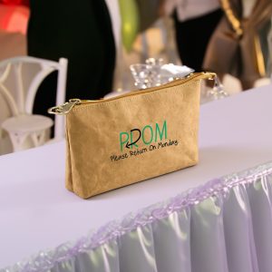A brown Kraft paper cosmetic bag with a zip closure and a logo featuring green text.