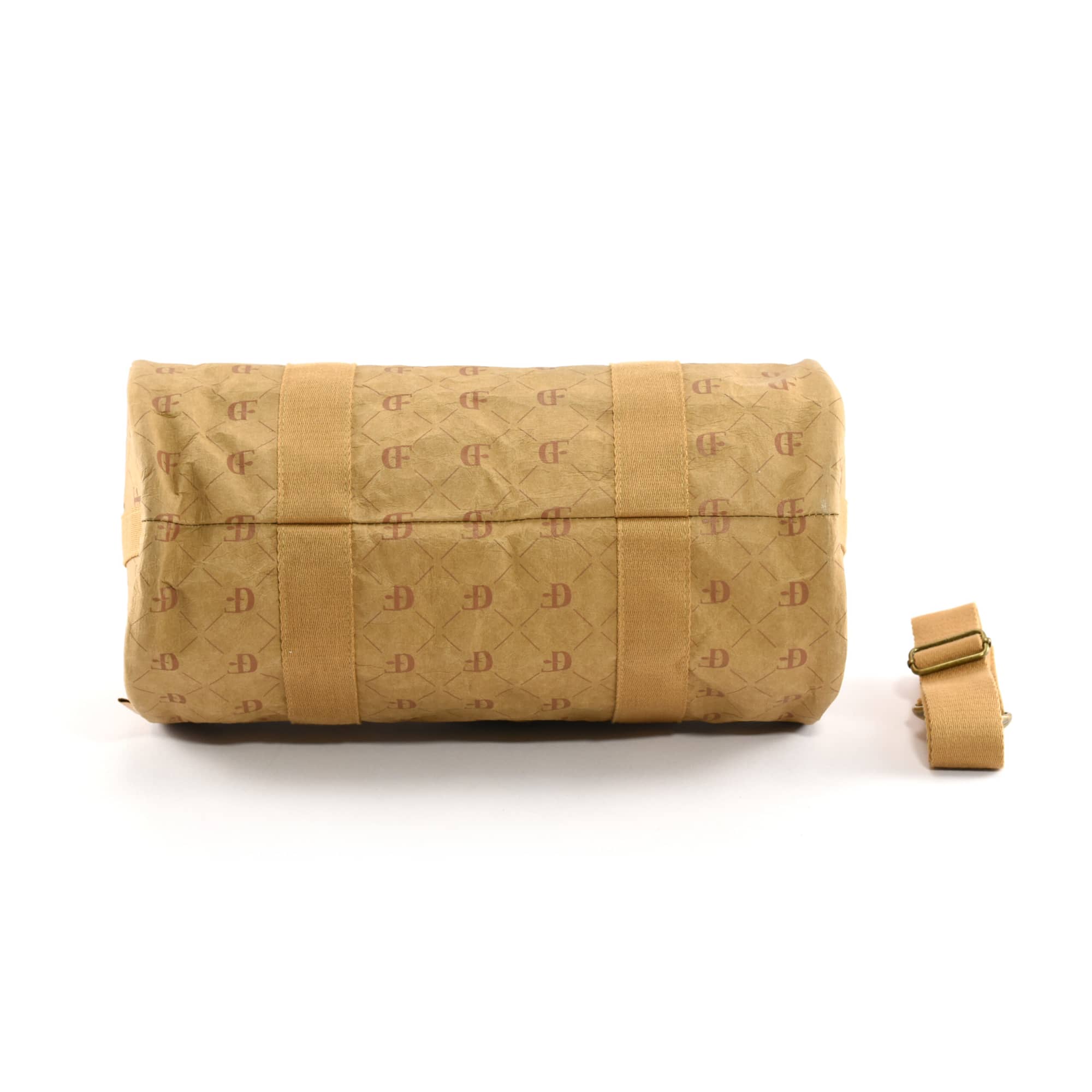 A Manila kraft paper duffle bag in a tan colour with a matching adjustable strap. It features an exterior logo.