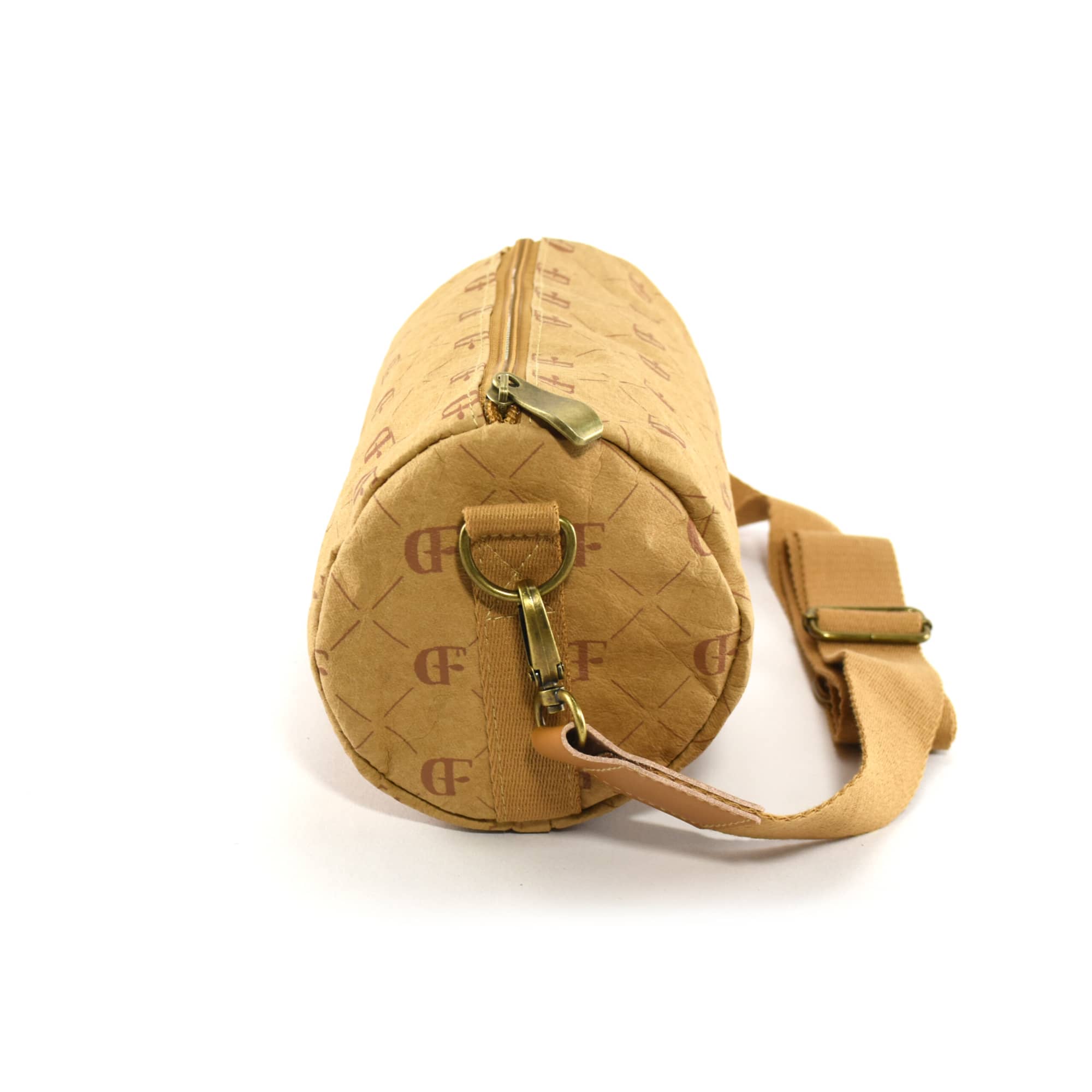 A round, tan kraft paper duffle bag with a zip closure and adjustable strap, featuring a logo print.