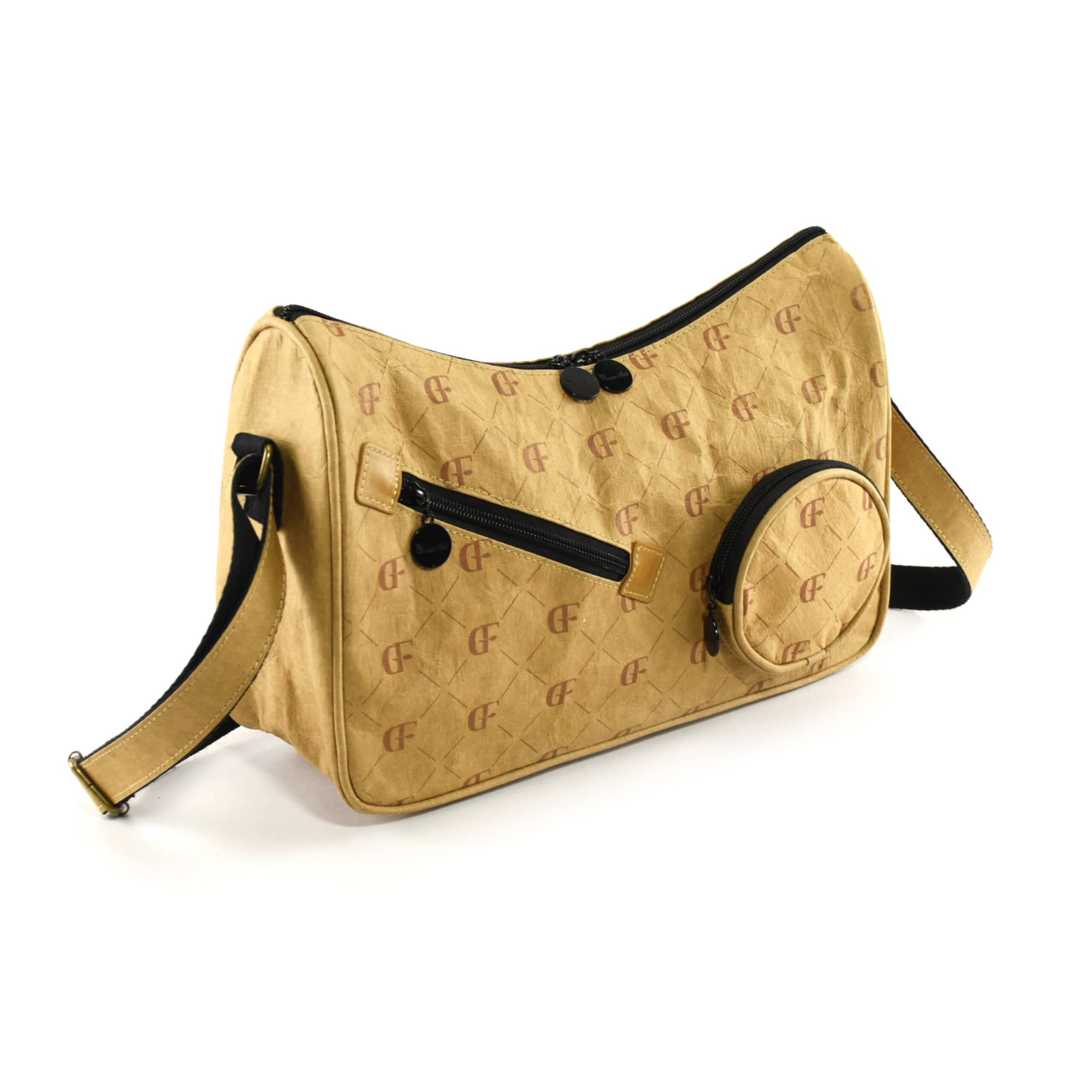 A karra kraft paper sling bag in a light brown hue with a black strap, featuring zippered compartments and a round pocket.
