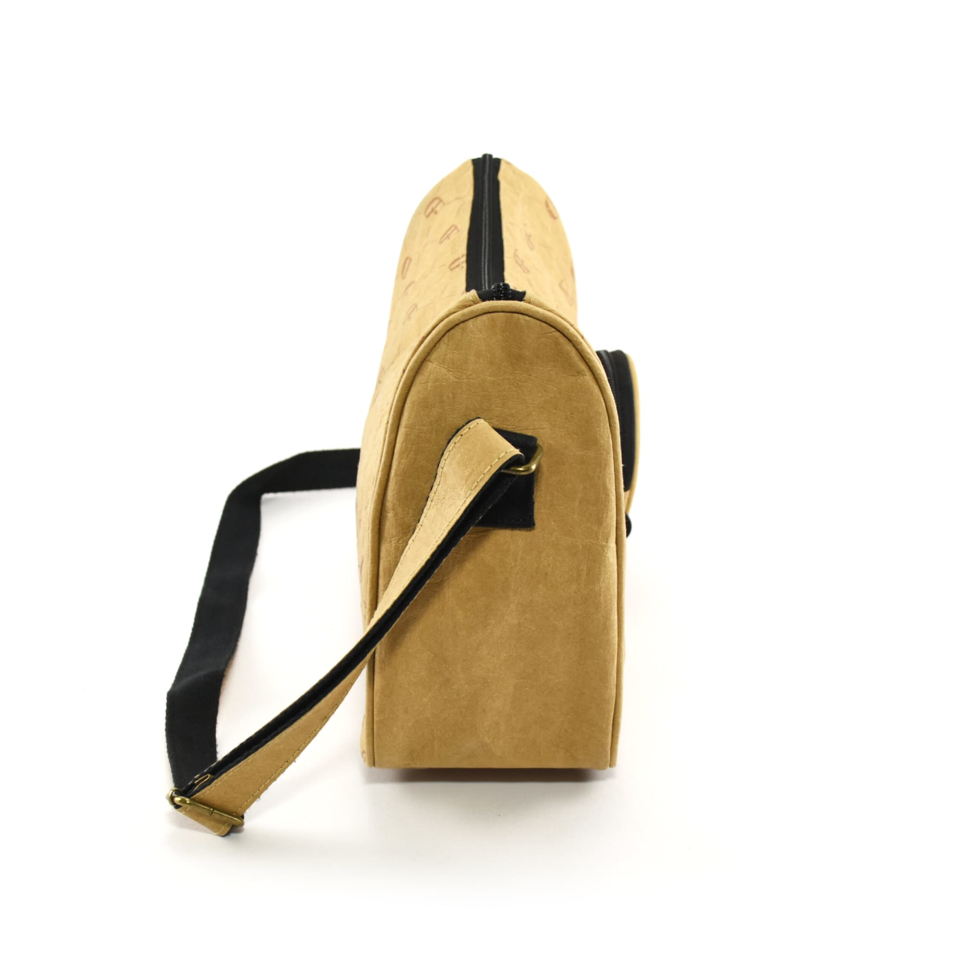 A kraft paper sling bag in a tan colour with a black strap, featuring a zip closure and branding on the surface.