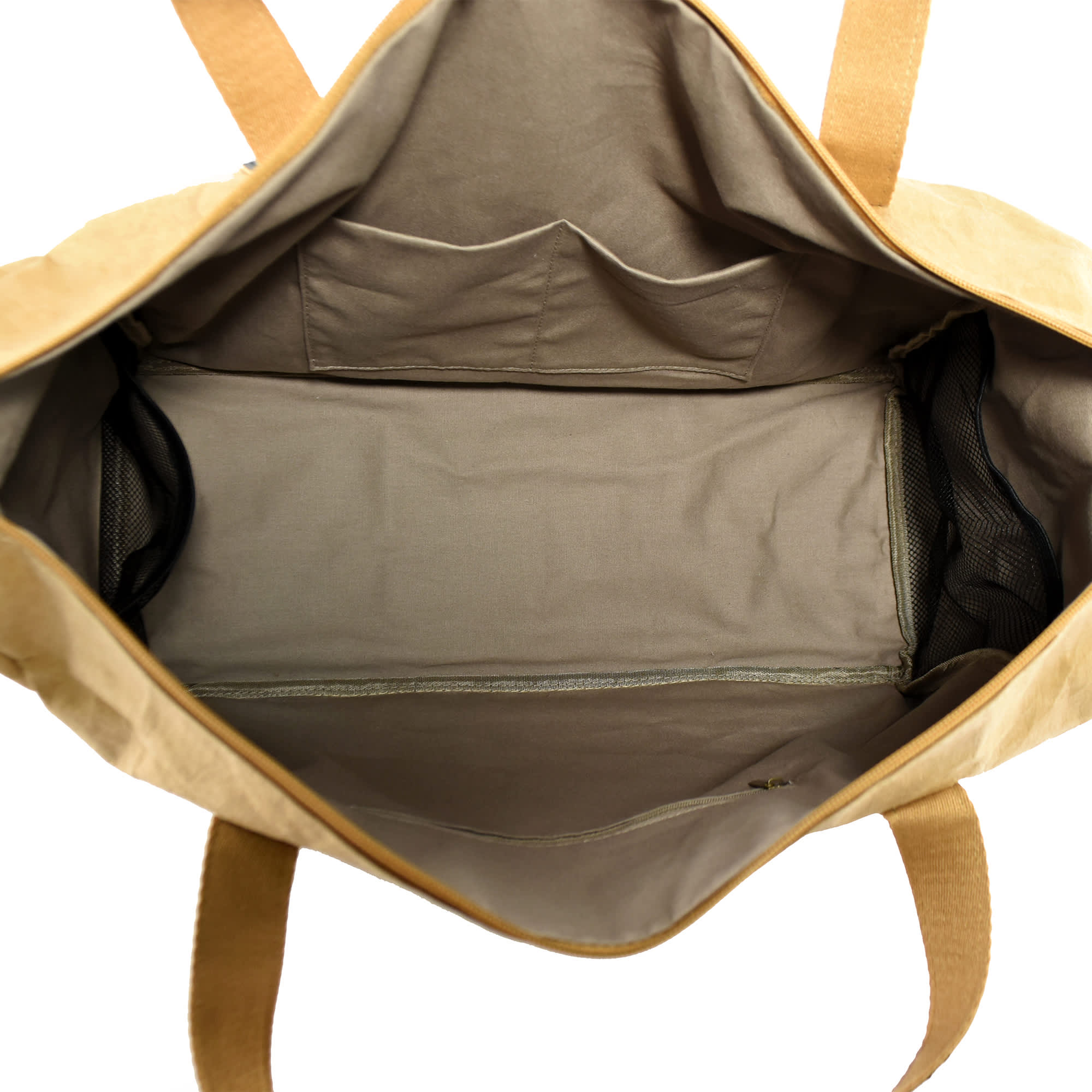 A large, tan Kraft paper travel bag with a spacious interior and multiple pockets. It features sturdy handles and a logo.