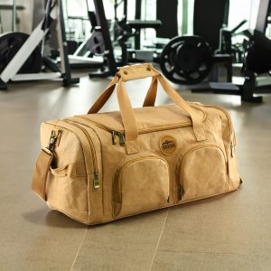 A tan kraft paper duffle bag with a logo, featuring two front pockets and sturdy handles.