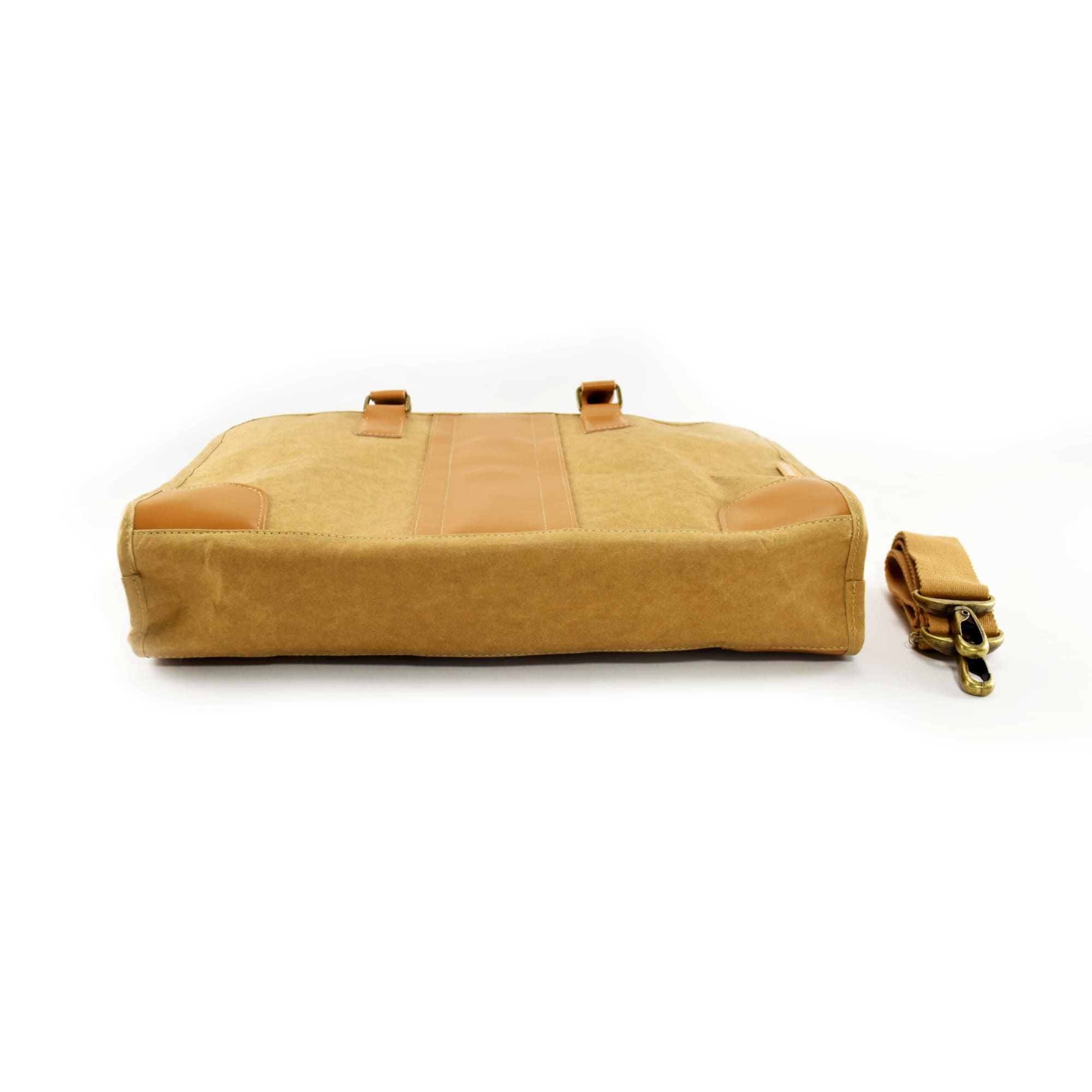 A tan kraft paper satchel with brown leather accents and a detachable strap. Features a simple design and branding.
